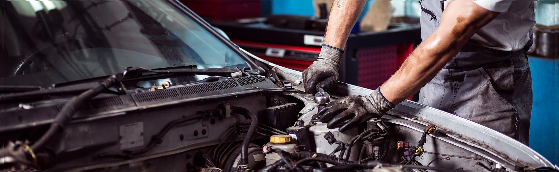 Mechanic repairing car engine.